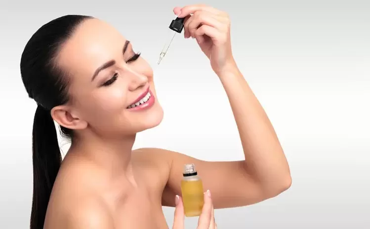 a woman who puts serum on her face
